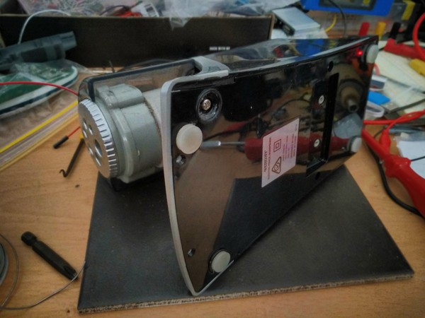 Sharpener on its side with sneaky screws exposed